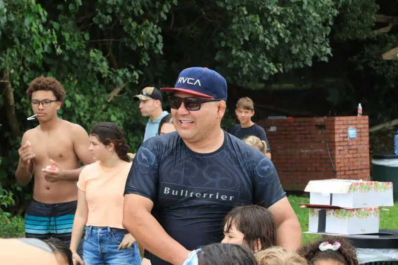Coach Ivan Sakamoto smiling at a team beach BBQ