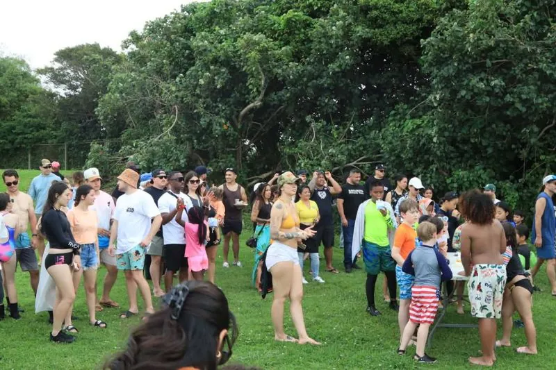 Team members and families at a BJJO beach gathering